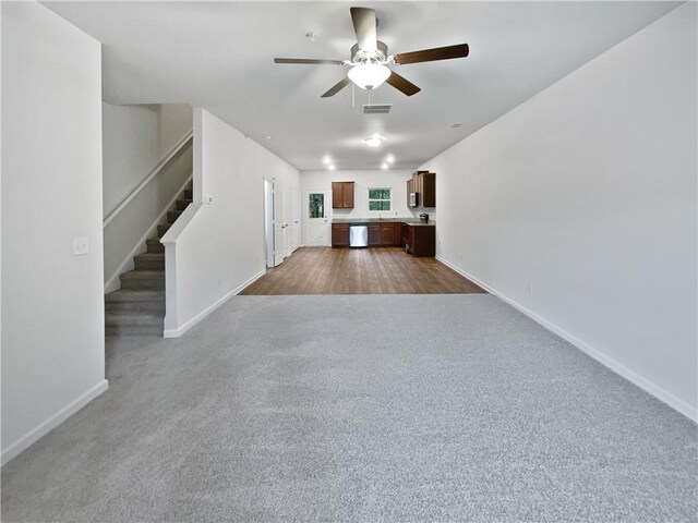 unfurnished living room featuring ceiling fan and hardwood / wood-style floors