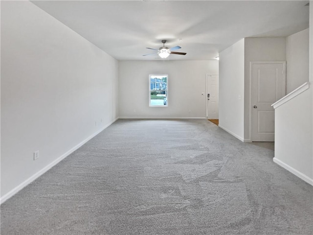 spare room featuring ceiling fan and light colored carpet