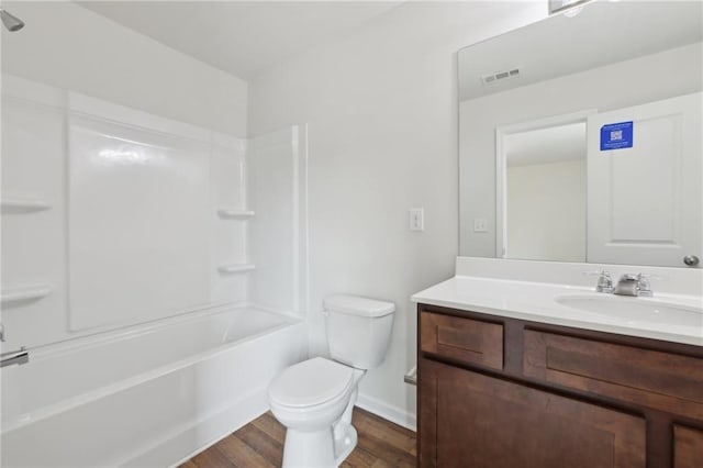 4001 Avalon Rd SW, Atlanta, GA 30331 - bathroom featuring visible vents, vanity, wood finished floors, toilet, and  shower combination