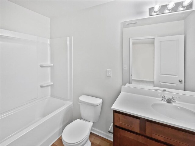 full bathroom with hardwood / wood-style floors, vanity, toilet, and bathtub / shower combination