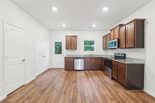 4001 Avalon Rd SW, Atlanta, GA 30331 - kitchen featuring appliances with stainless steel finishes, a sink, and light wood finished floors