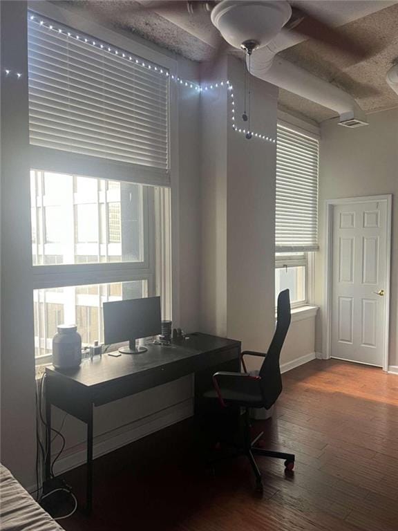 home office with wood-type flooring and ceiling fan