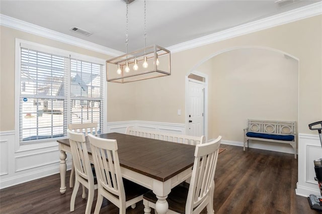 dining area with ornamental molding, dark hardwood / wood-style floors, and a healthy amount of sunlight