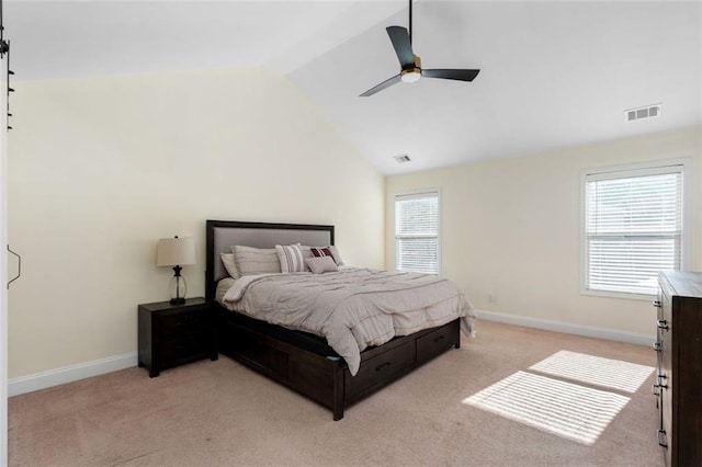 bedroom featuring ceiling fan, lofted ceiling, and light carpet