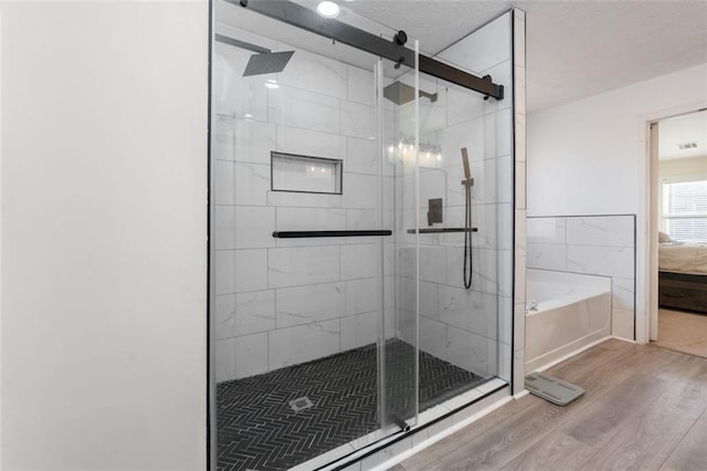 bathroom with plus walk in shower and hardwood / wood-style floors