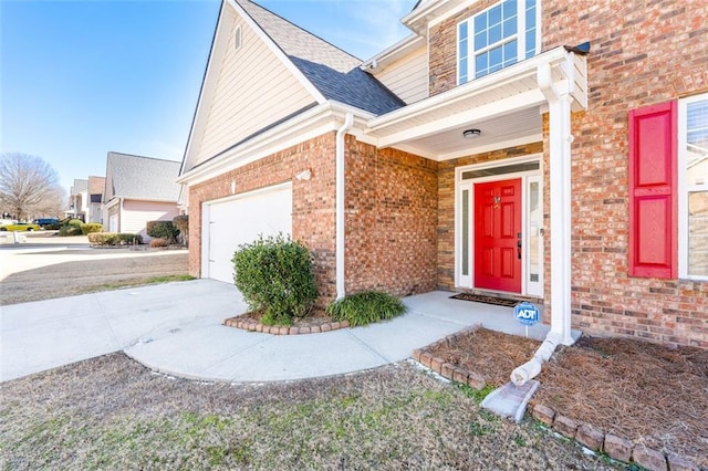 doorway to property with a garage