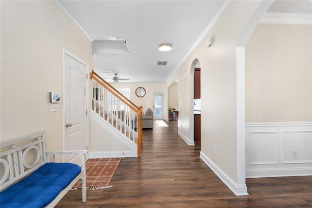 entrance foyer with ornamental molding and dark hardwood / wood-style flooring