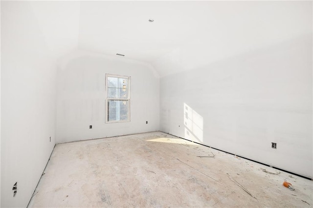 spare room featuring lofted ceiling