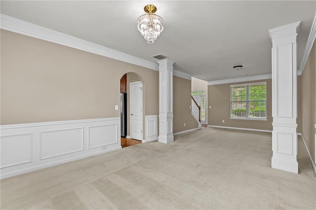 3039 Tuscan Ridge Dr, Snellville, GA 30039 - unfurnished living room with ornate columns, light colored carpet, arched walkways, ornamental molding, and stairway
