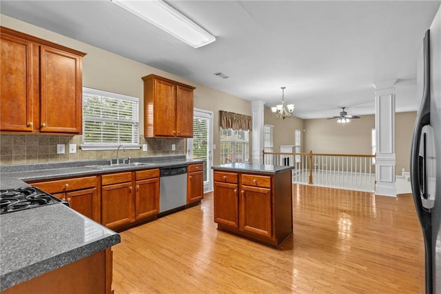 3039 Tuscan Ridge Dr, Snellville, GA 30039 - kitchen featuring dishwasher, a sink, ceiling fan, ornate columns, and dark countertops