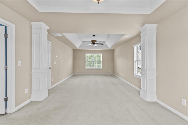 3039 Tuscan Ridge Dr, Snellville, GA 30039 - unfurnished room featuring a tray ceiling, ornate columns, a ceiling fan, and light colored carpet