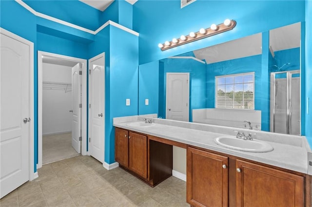 3039 Tuscan Ridge Dr, Snellville, GA 30039 - bathroom featuring a shower stall, double vanity, and a walk in closet