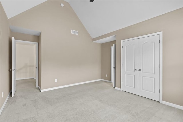 3039 Tuscan Ridge Dr, Snellville, GA 30039 - unfurnished bedroom featuring light colored carpet, a closet, baseboards, and high vaulted ceiling