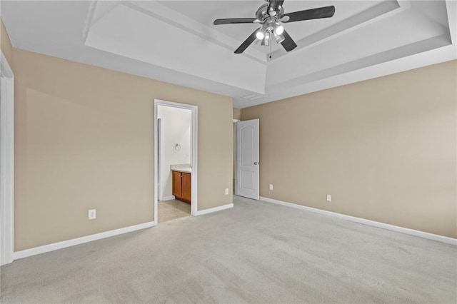 3039 Tuscan Ridge Dr, Snellville, GA 30039 - unfurnished bedroom with a tray ceiling, light carpet, baseboards, ensuite bath, and a ceiling fan