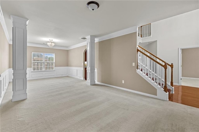 3039 Tuscan Ridge Dr, Snellville, GA 30039 - spare room with ornate columns, light carpet, ornamental molding, a chandelier, and stairs