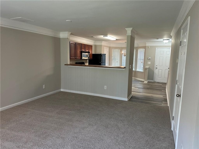 interior space featuring black refrigerator, dark colored carpet, kitchen peninsula, and a chandelier