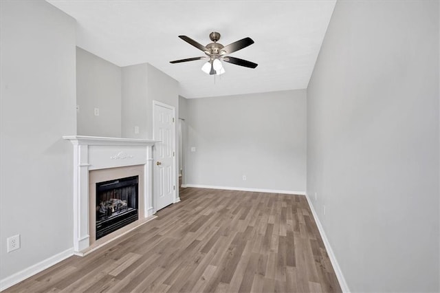 unfurnished living room featuring light hardwood / wood-style floors and ceiling fan