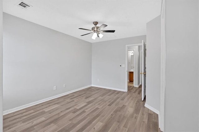 spare room featuring ceiling fan and light hardwood / wood-style floors