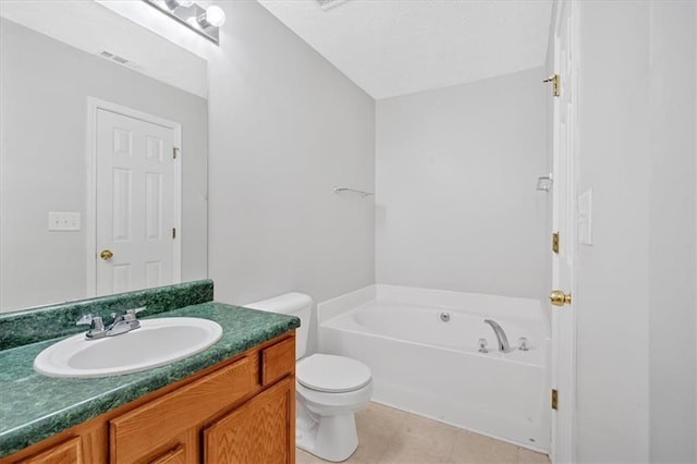 bathroom featuring tile patterned floors, vanity, toilet, and a tub