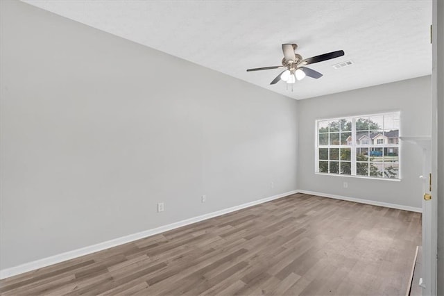 empty room with ceiling fan and wood-type flooring