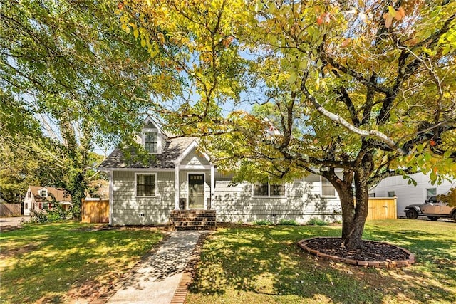 view of front of home featuring crawl space, a front lawn, and fence