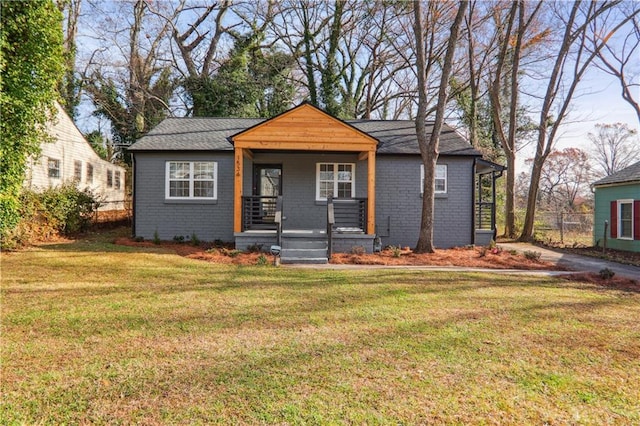 bungalow-style house with covered porch and a front lawn