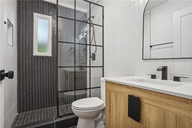 bathroom featuring tiled shower, toilet, tile walls, vanity, and decorative backsplash