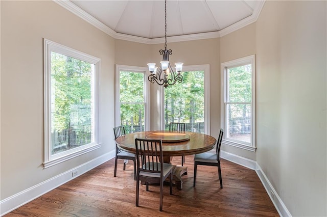 dining room featuring a chandelier, baseboards, crown molding, and dark wood-type flooring