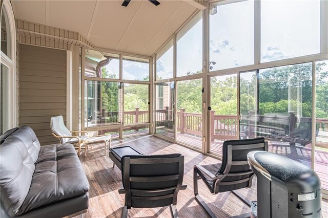 sunroom / solarium with plenty of natural light, ceiling fan, and an outdoor hangout area
