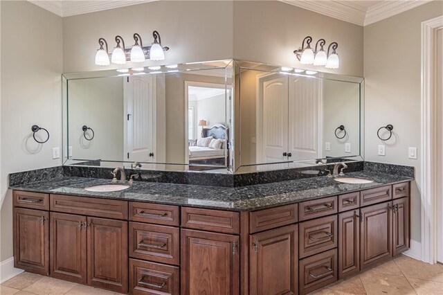 full bathroom with tile patterned floors, double vanity, connected bathroom, ornamental molding, and baseboards