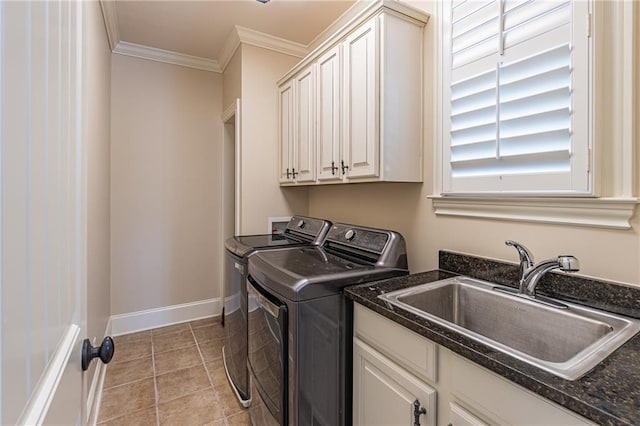 laundry room with washer and clothes dryer, cabinet space, crown molding, light tile patterned floors, and baseboards