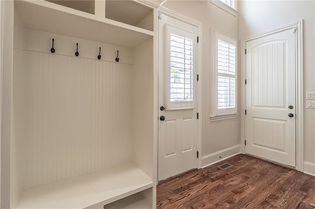mudroom with dark wood-style floors and baseboards