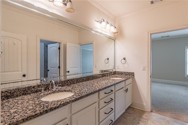 full bath featuring ornamental molding, baseboards, and double vanity