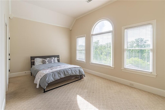 bedroom with vaulted ceiling, ornamental molding, multiple windows, baseboards, and carpet flooring