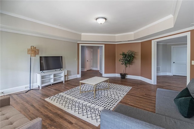 living area with wood finished floors, baseboards, and ornamental molding