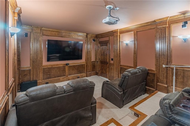 cinema room with carpet floors, wooden walls, and a decorative wall