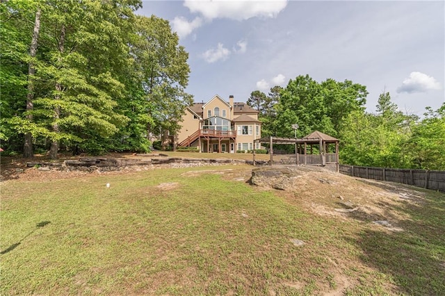 view of yard with a gazebo, a wooden deck, and stairs