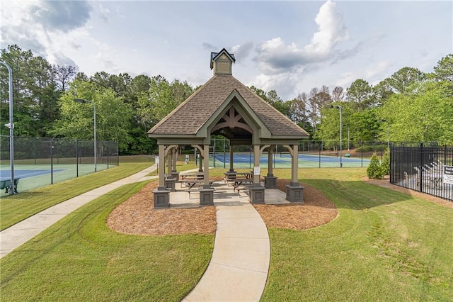 view of community with a gazebo and view of wooded area