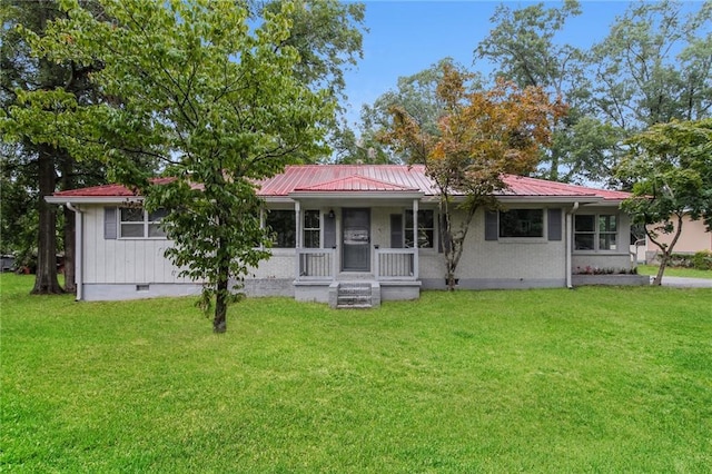 back of property with covered porch and a yard