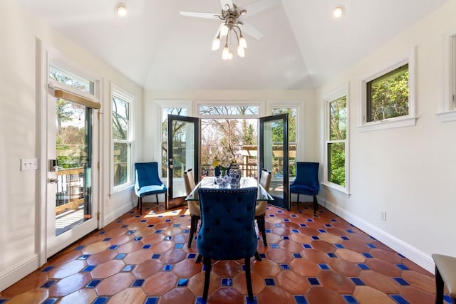 sunroom / solarium featuring vaulted ceiling, a wealth of natural light, and a ceiling fan