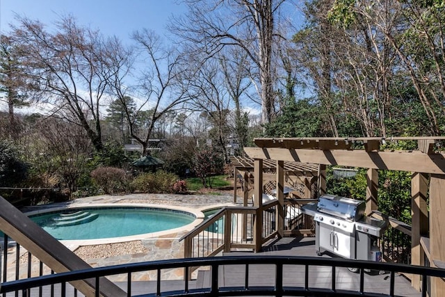 outdoor pool featuring a grill