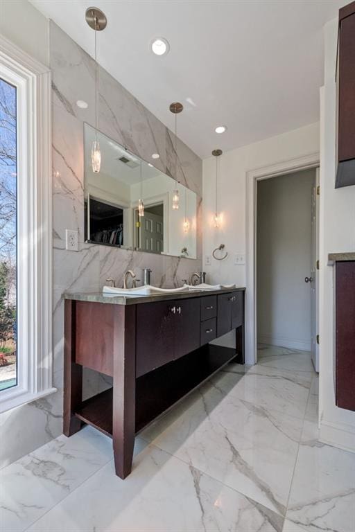 full bath featuring recessed lighting, marble finish floor, a sink, and double vanity