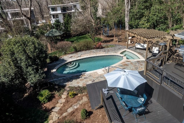 view of pool featuring a pool with connected hot tub and a pergola