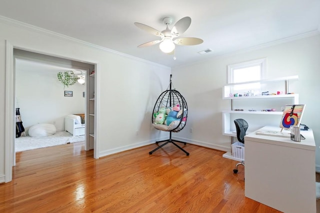 home office with ornamental molding, light wood finished floors, and visible vents