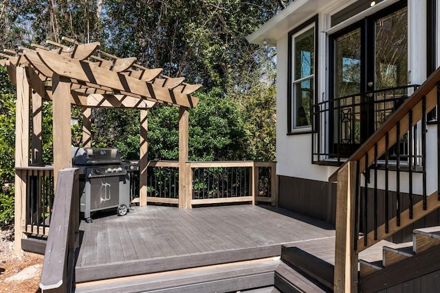 wooden deck with a grill and a pergola