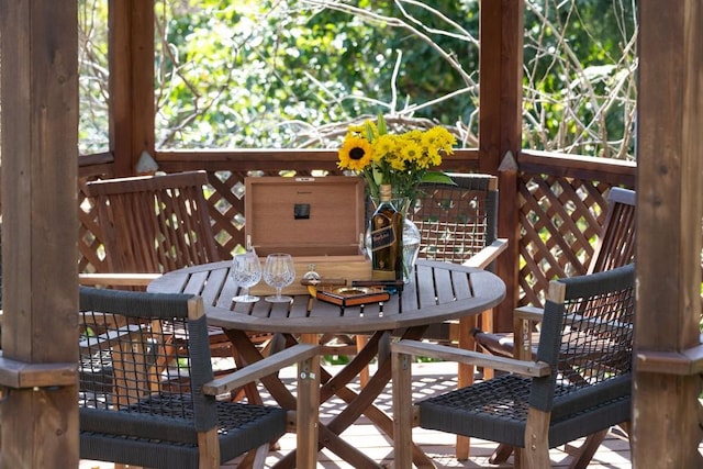 wooden terrace with outdoor dining area