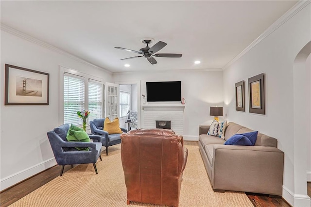 728 Antone St NW, Atlanta, GA 30318 - living area featuring arched walkways, baseboards, a ceiling fan, wood finished floors, and crown molding