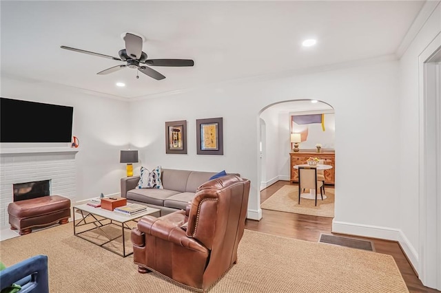 728 Antone St NW, Atlanta, GA 30318 - living area featuring arched walkways, a ceiling fan, wood finished floors, baseboards, and a fireplace