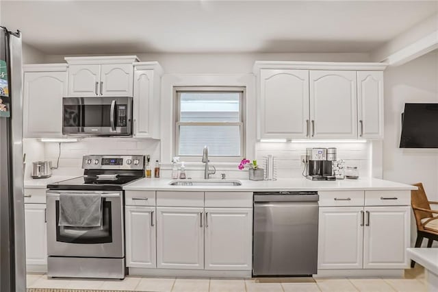 728 Antone St NW, Atlanta, GA 30318 - kitchen featuring stainless steel appliances, a sink, tasteful backsplash, and white cabinets