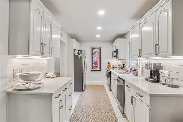 728 Antone St NW, Atlanta, GA 30318 - kitchen with stainless steel appliances, backsplash, recessed lighting, arched walkways, and white cabinets